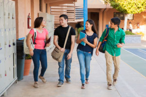 high school students talk in hallway