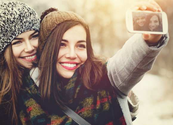 two teenage girls pose for winter selfie