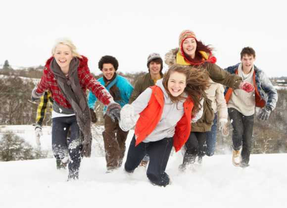 group of young adults playing in winter