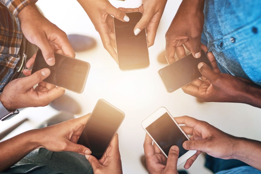 hands and group of friends using mobile phones