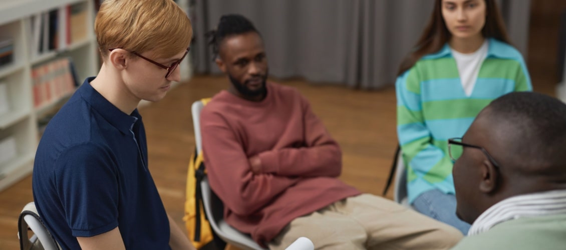 depressed young man talking to a counsellor